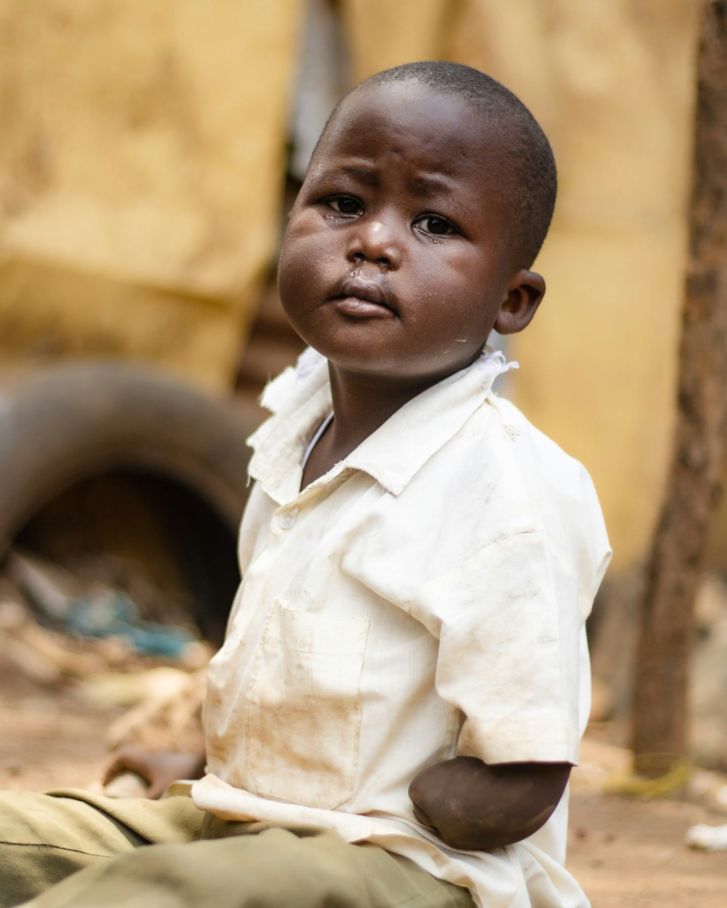 A little boy in a cream shirt